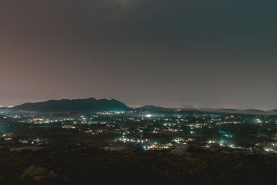 High angle view of illuminated buildings in city at night