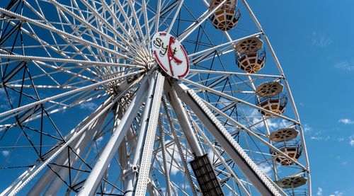 Low angle view of ferris wheel against sky