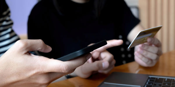 Midsection of woman using mobile phone