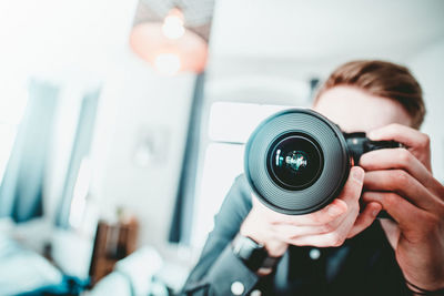 Close-up of man photographing at home