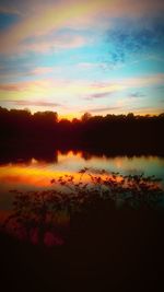 Scenic view of silhouette landscape against orange sky