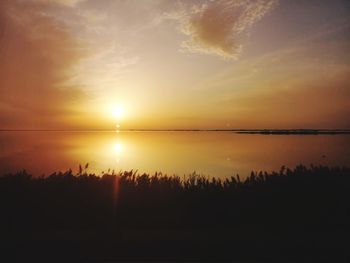 Scenic view of sunset over lake