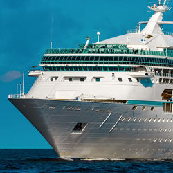 Ship moored in sea against blue sky