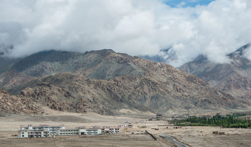 Panoramic view of people on mountains against sky