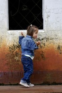 Boy standing against wall