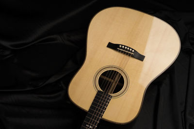 High angle view of guitar on bed