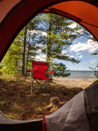 Sea seen through tent against sky