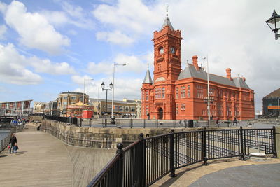 Pierhead building against cloudy sky