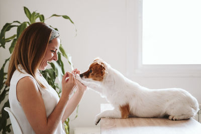 Side view of young woman with dog