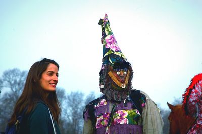 Woman with multi colored umbrellas against sky