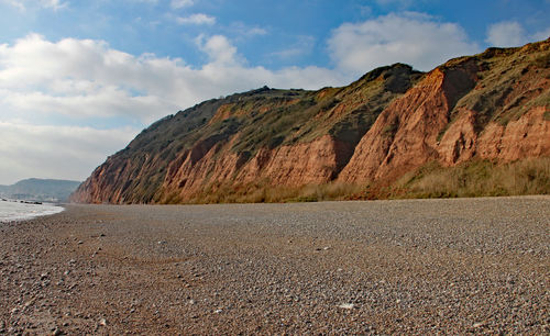 Scenic view of sea and mountains against sky