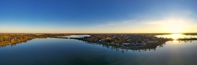 Scenic view of river against sky during sunset