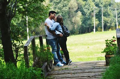 Full length of couple walking in forest