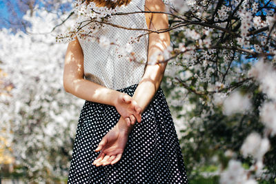 Rear view midsection of woman in springtime