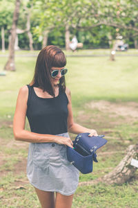 Young woman wearing sunglasses on field