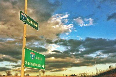 Information sign on pole against sky