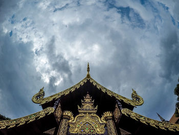 Low angle view of temple against cloudy sky