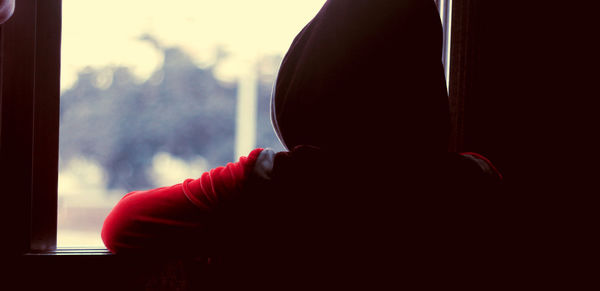 Close-up of person against window