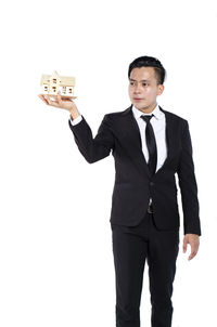 Portrait of young man standing against white background