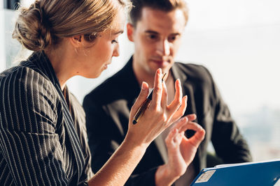 Side view of young woman using mobile phone