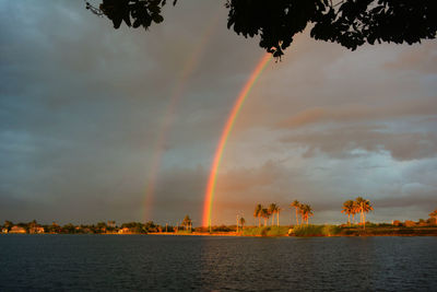 Scenic view of rainbow against sky during sunset