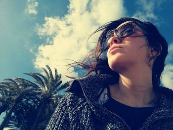 Woman looking away against sky