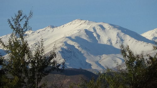 Low angle view of mountains against clear blue sky