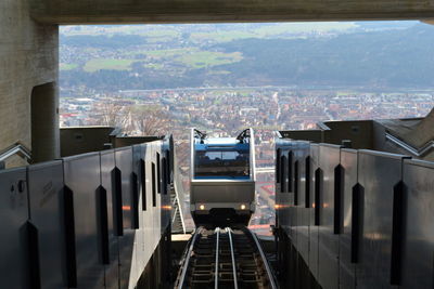 View of a funicular climbing up an escalator with the alps in the background