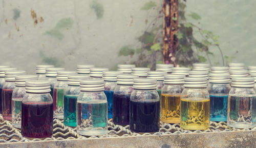 Close-up of multi colored bottles in jar