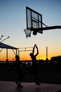 Silhouette of woman at sunset