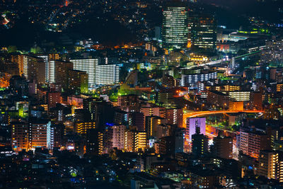 High angle view of illuminated city buildings at night