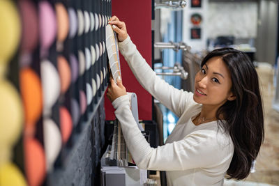 Businesswoman holding color swatch at office