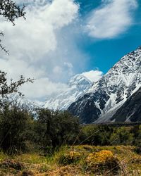 Scenic view of mountains against cloudy sky