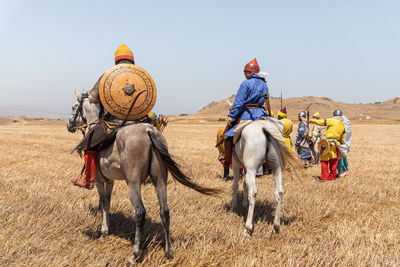 Group of people riding motorcycle on land