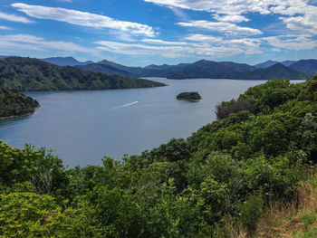 Scenic view of sea and mountains against sky