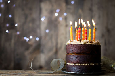 Close-up of illuminated candles on table