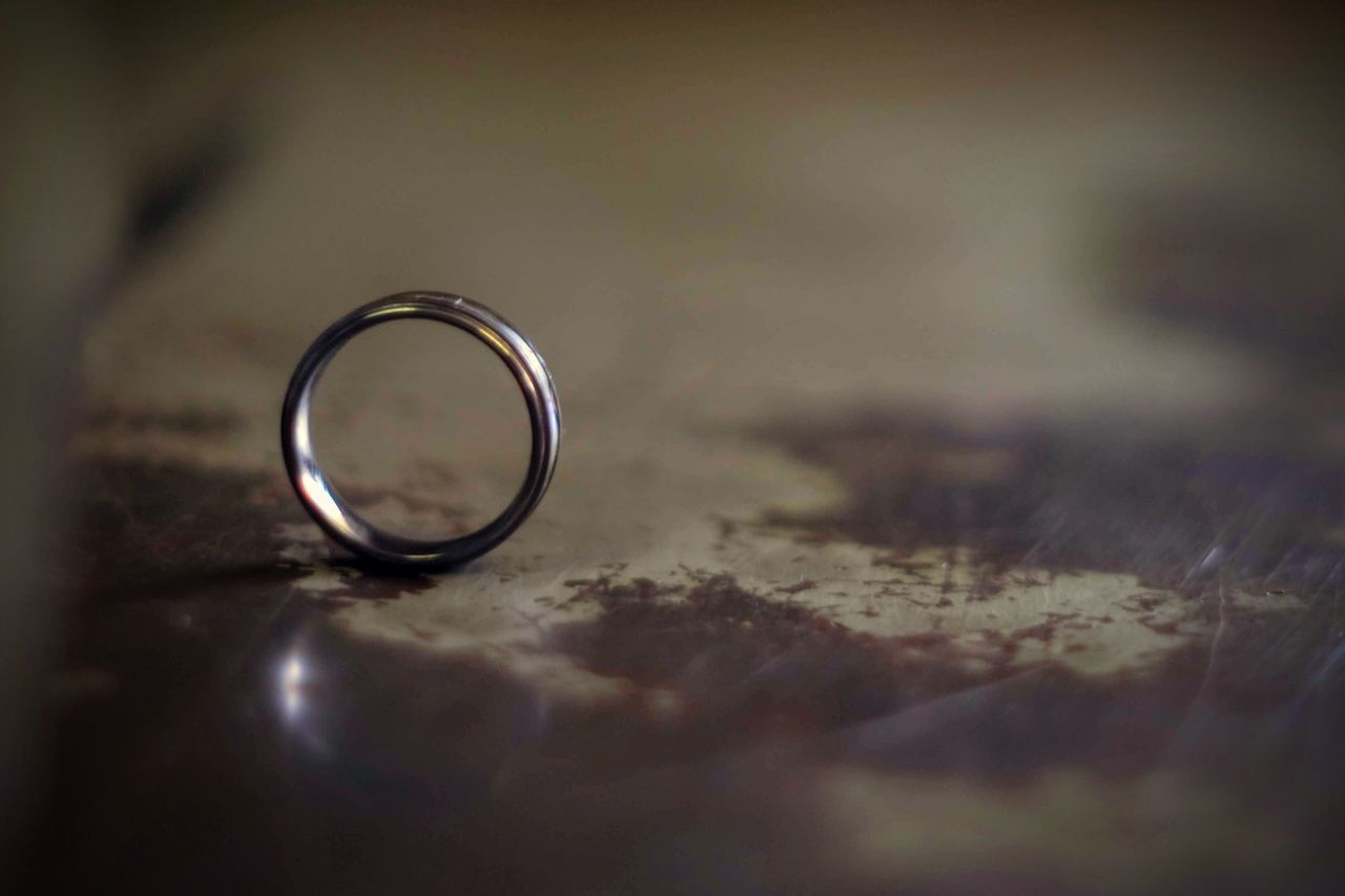 CLOSE-UP OF WEDDING RINGS ON TABLE