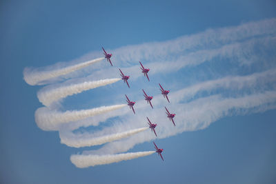 Low angle view of airshow against sky