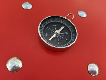 Close-up of clock against red background