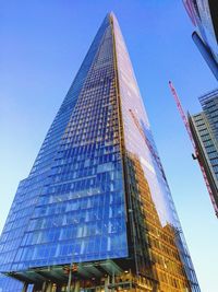 Low angle view of modern buildings against clear blue sky