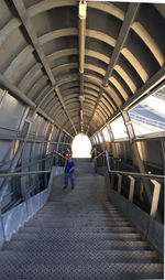 High angle view of boy wearing mask standing on steps