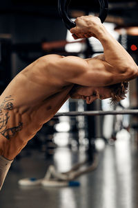 Cropped hand of man exercising in gym