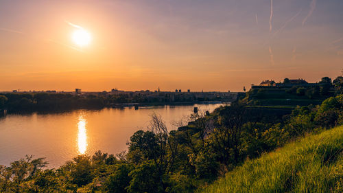 Scenic view of lake against sky during sunset