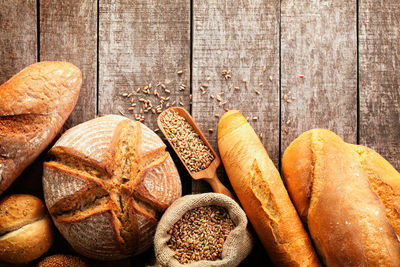 Directly above view of baked bread and wheat on table