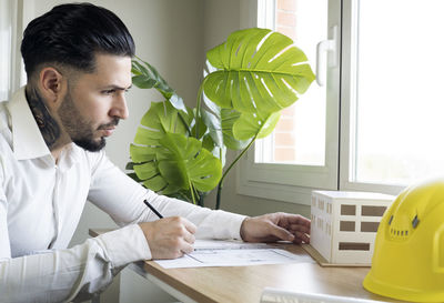 Young man looking at camera on table