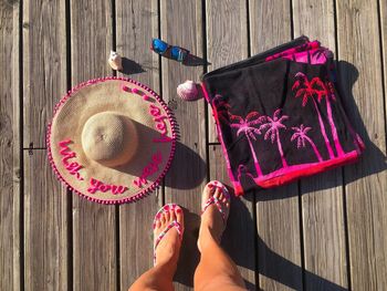 Low section of woman with umbrella on wooden table