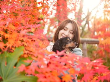 Young woman with dog in autumn