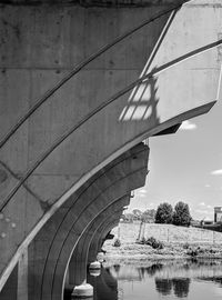 Arch bridge over river against sky