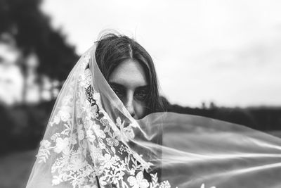 Close-up portrait of woman with scarf standing outdoors