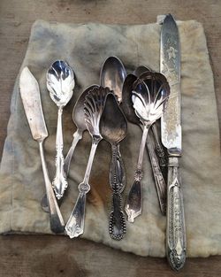 High angle view of spoon and table knife on fabric at table